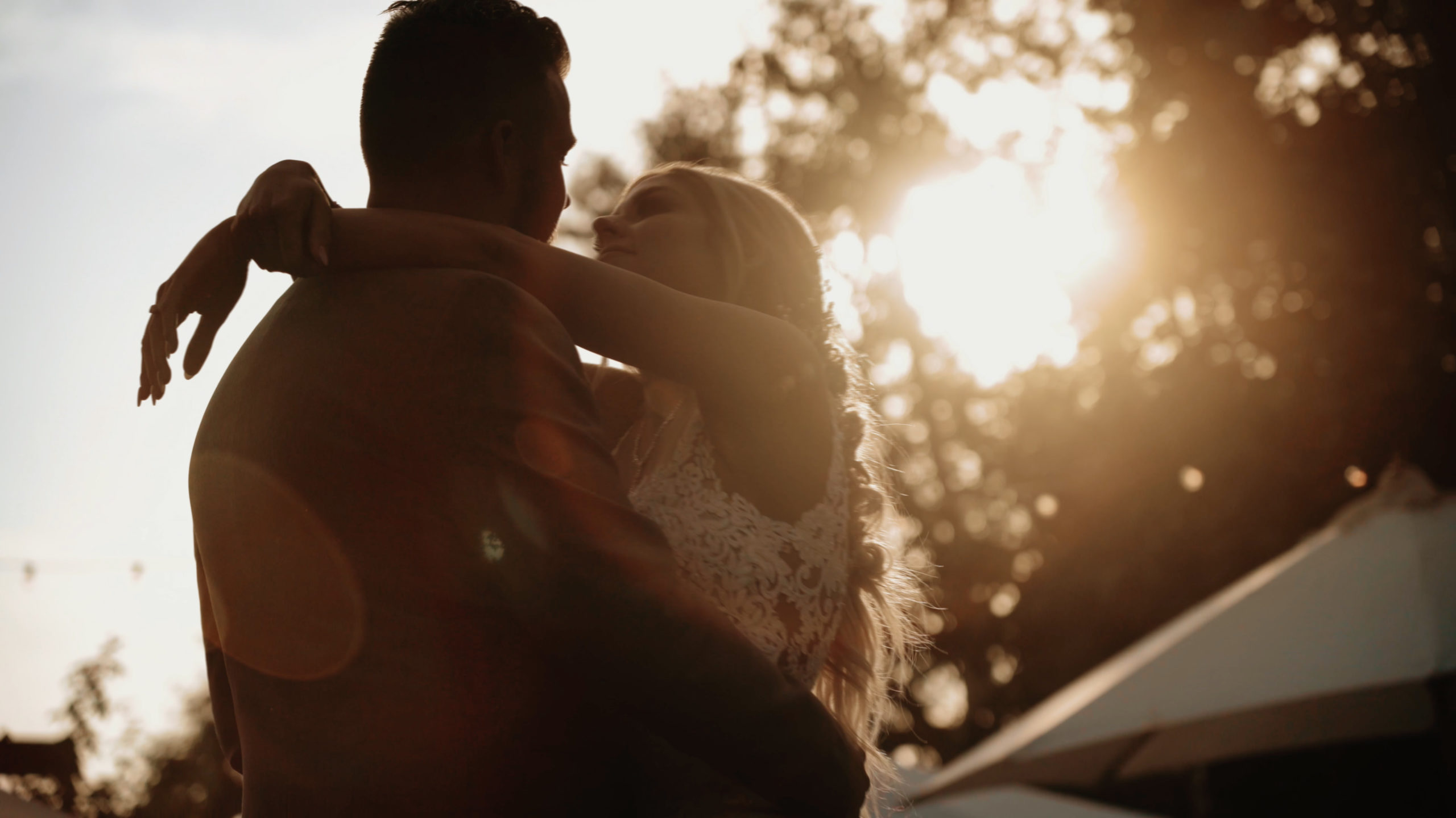 Bride and groom share a romantic dance in golden sunset light at The Homestead, captured in a dreamy wedding teaser moment.