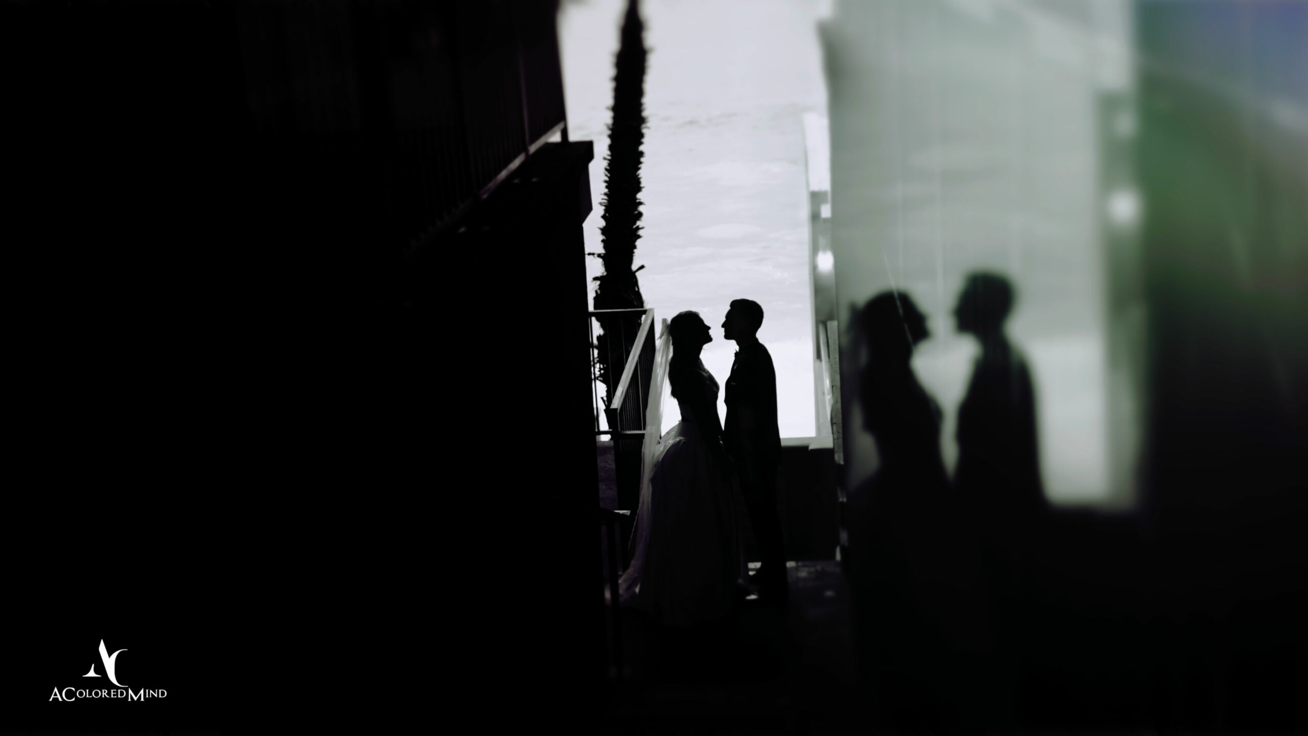 Silhouetted bride and groom share a quiet moment near glass reflections at Surf & Sand Resort wedding highlight in Laguna Beach.