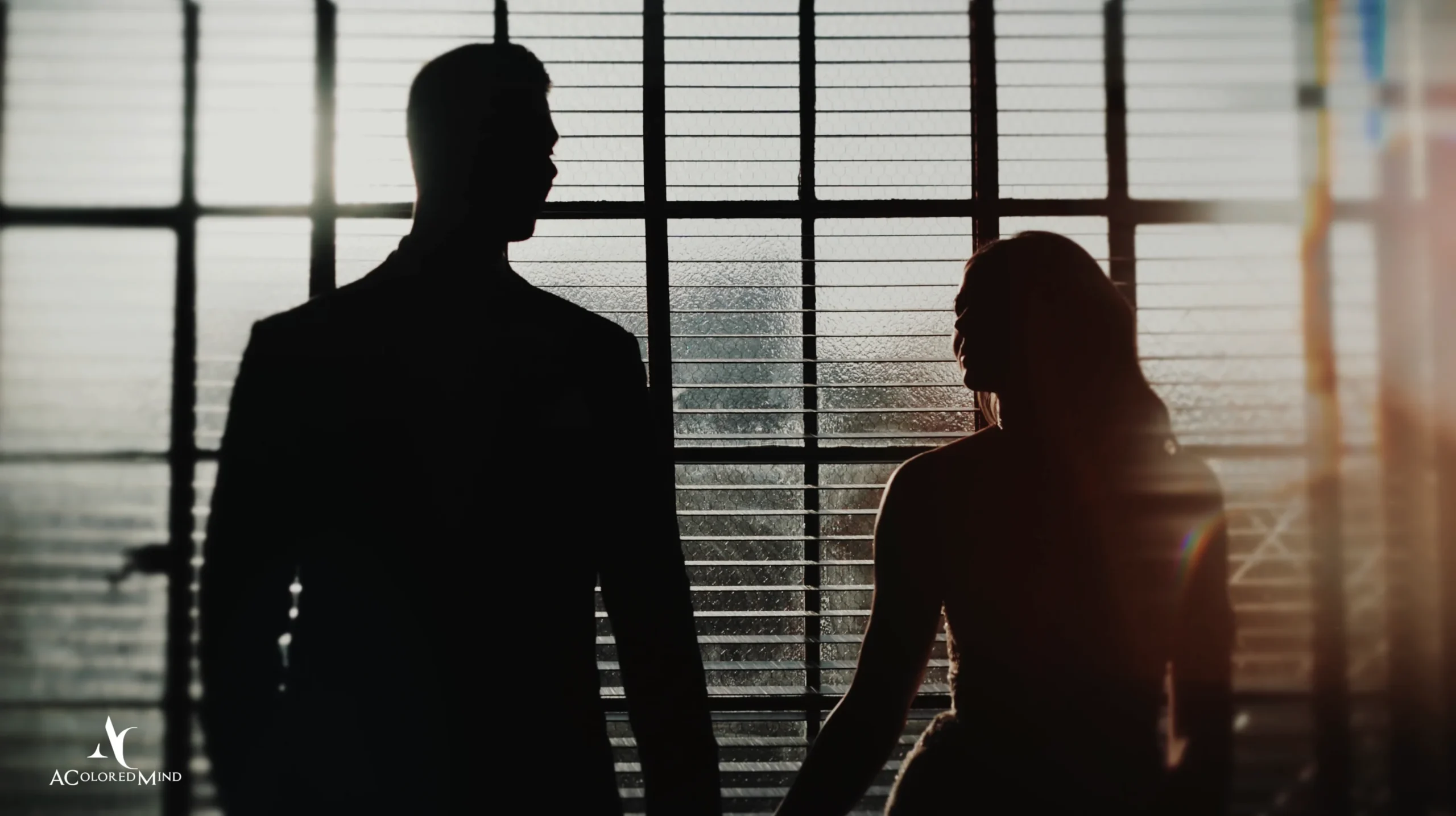 Bride and groom silhouette in front of large sunlit windows on the third floor at The Ebell of Los Angeles wedding venue.
