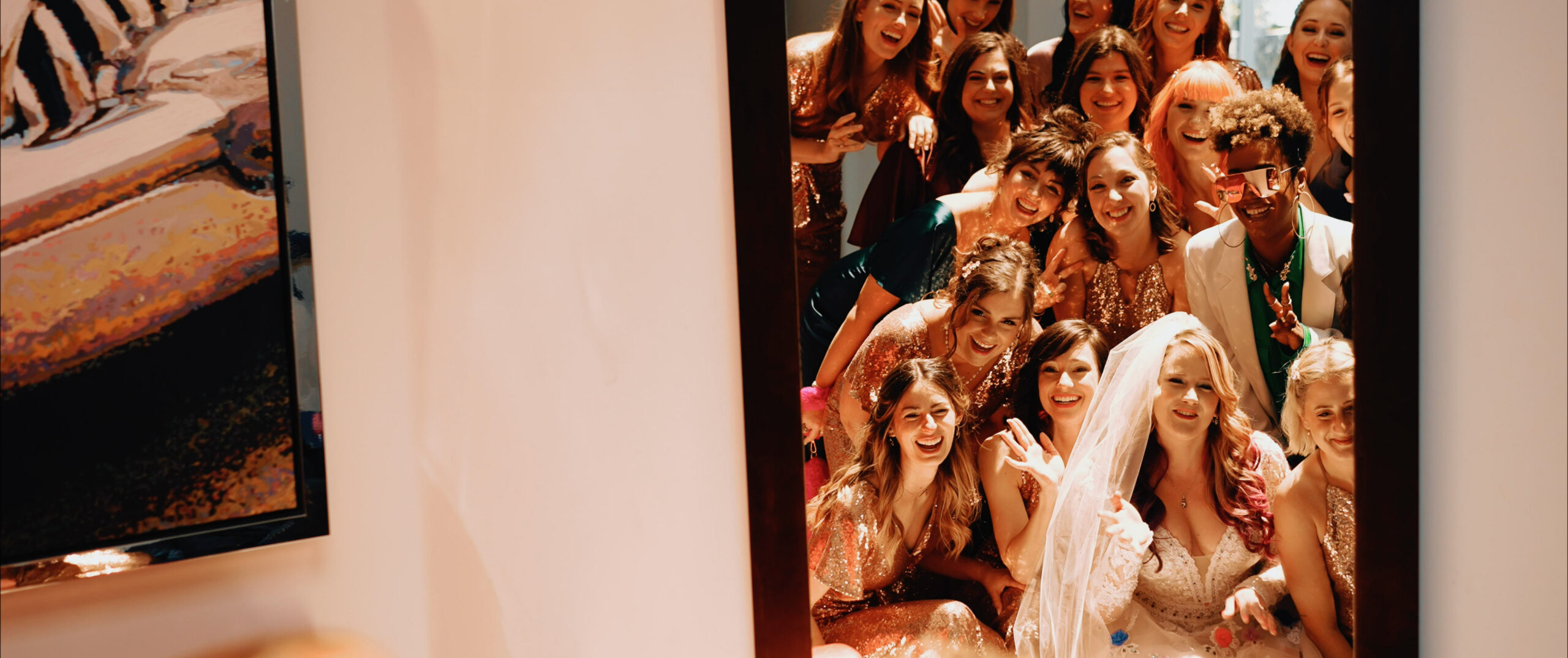 Bride with bridal party captured in a joyful mirror reflection before the ceremony at Malibu Sea View Estate wedding celebration.