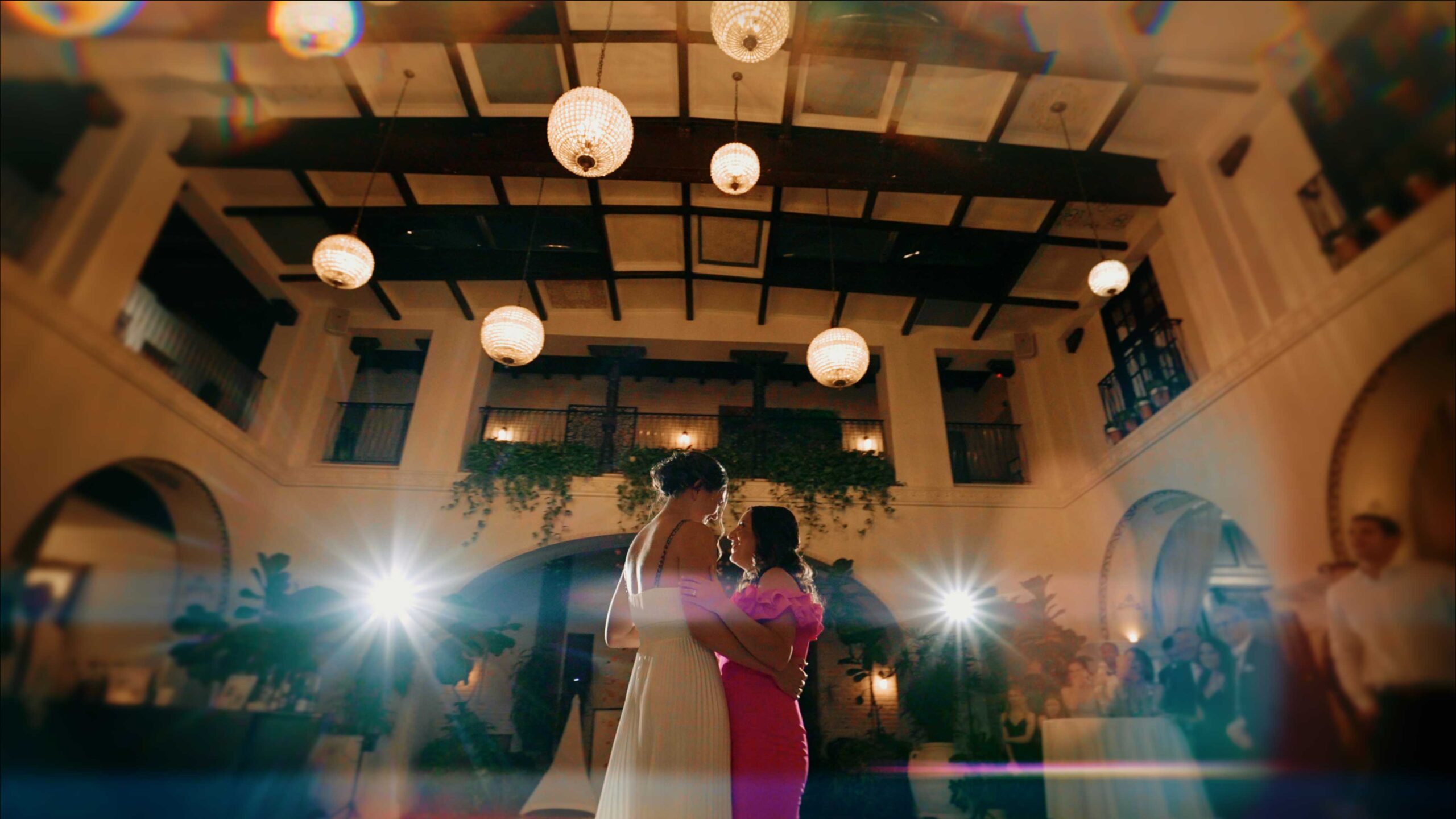 Two brides sharing their first dance at a cinematic LGBTQ wedding at the Ebell of Long Beach, documented by a Los Angeles same-sex wedding videographer.