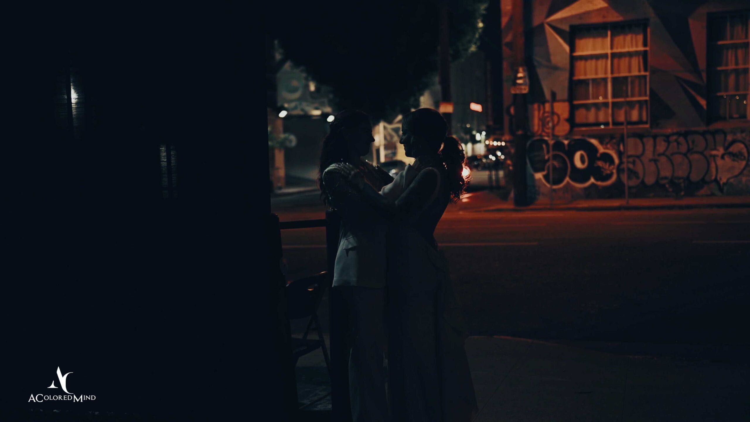 Cinematic night portrait of two brides during their Millwick wedding in Downtown Los Angeles, captured by an expert LGBTQ+ wedding videographer.