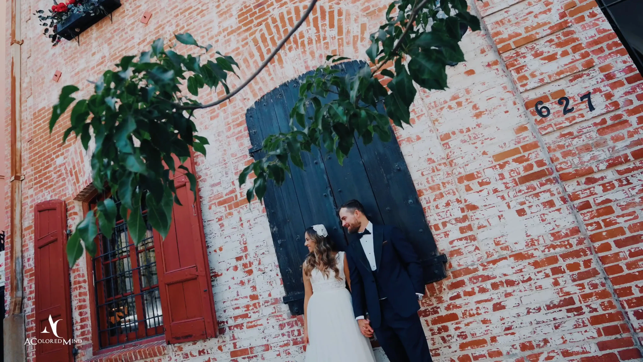 Carondelet House wedding videography highlights featuring a couple posing outside the historic brick venue in Los Angeles.