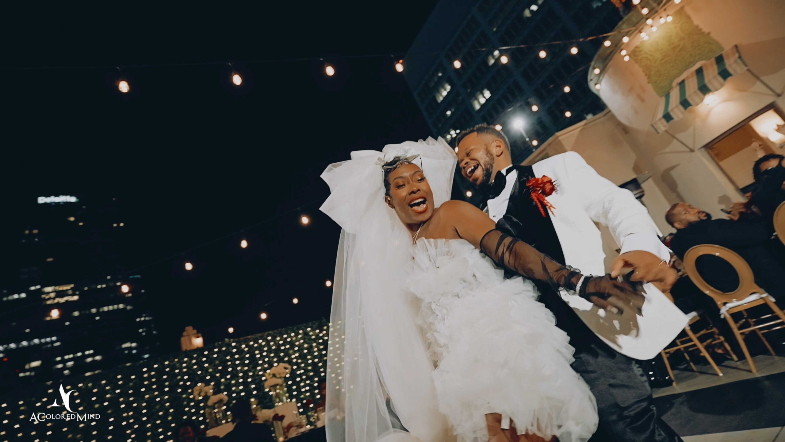 Courtney and Nikki dancing joyfully at their rooftop wedding reception at The Oviatt in downtown Los Angeles filmed by A Colored Mind Wedding Films
