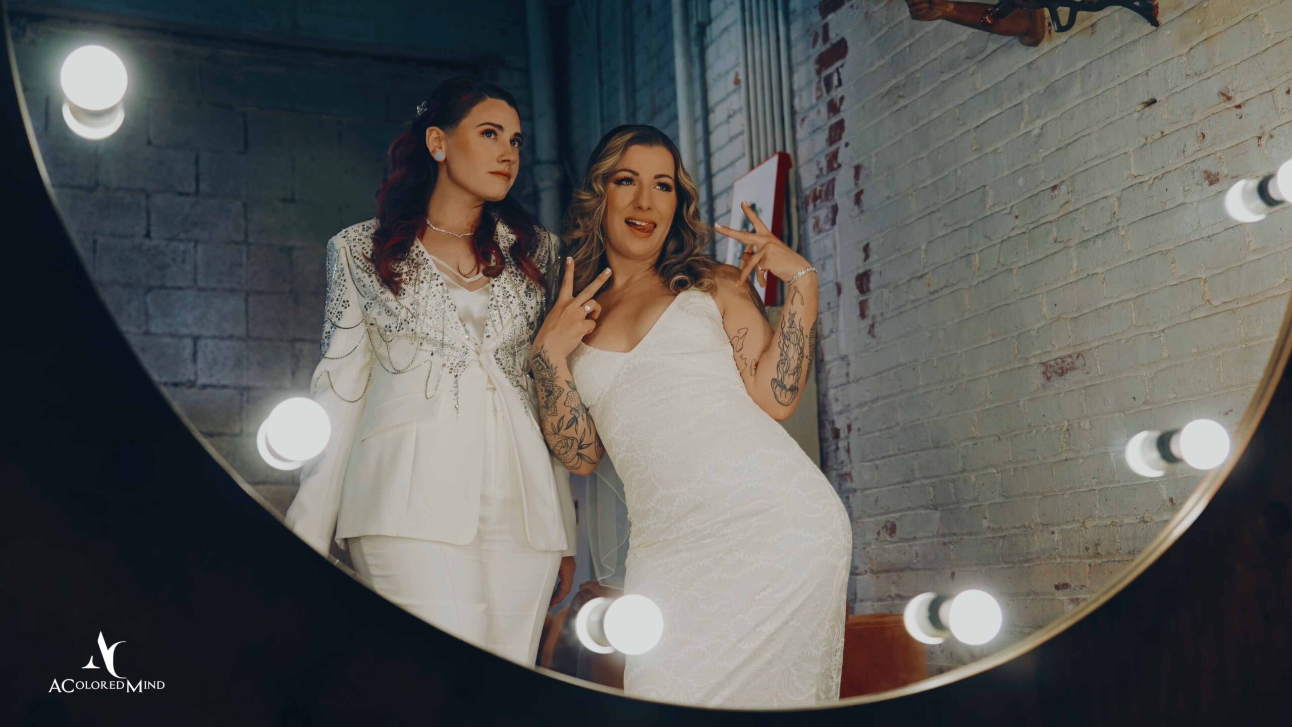 LGBTQ wedding couple posing in a mirror at Millwick in DTLA, filmed by a Los Angeles wedding videographer