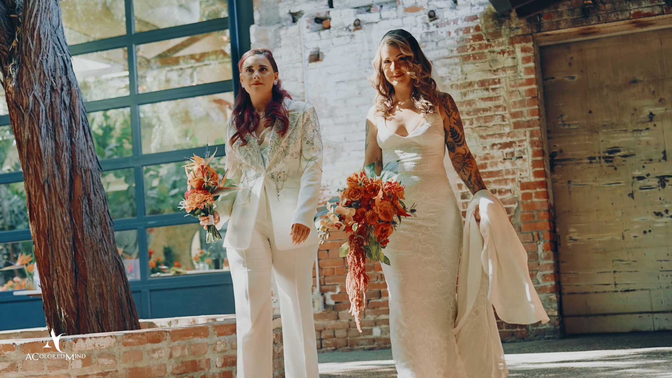 LGBTQ wedding couple walking with bouquets at Millwick in DTLA, filmed by a Los Angeles wedding videographer