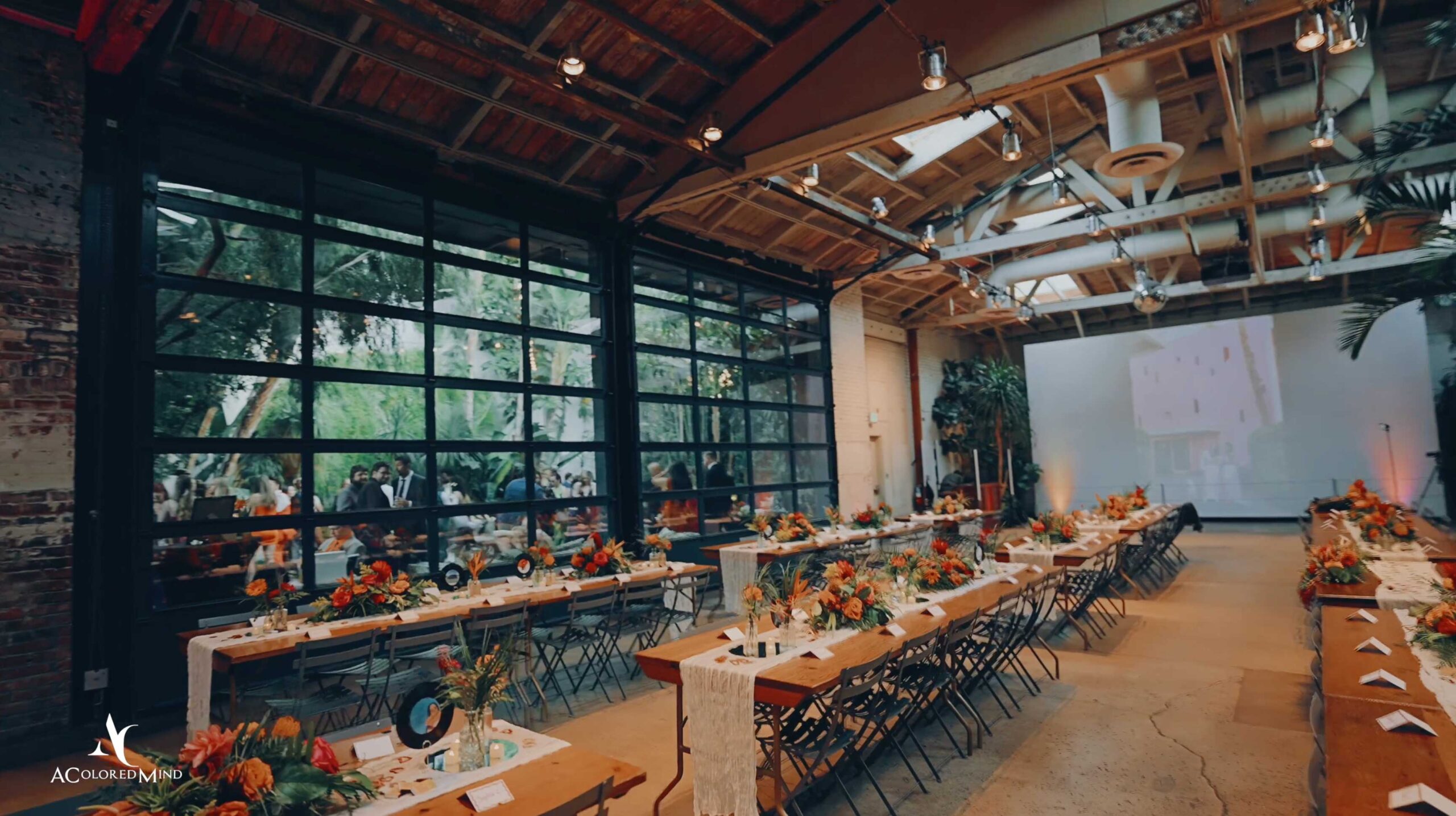 Wedding reception setup with long tables and floral arrangements inside Millwick Downtown LA.